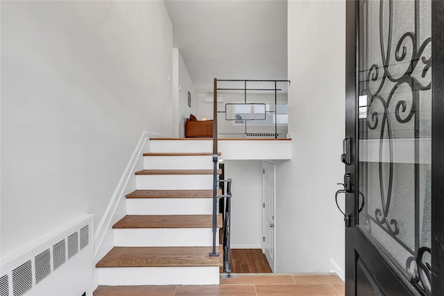 staircase with wood finished floors