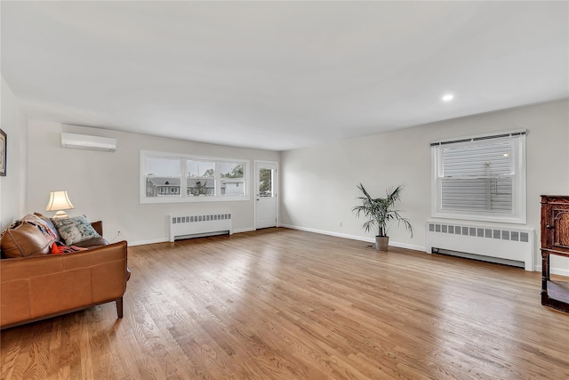 living area with radiator, a wall mounted AC, light wood-type flooring, baseboards, and recessed lighting