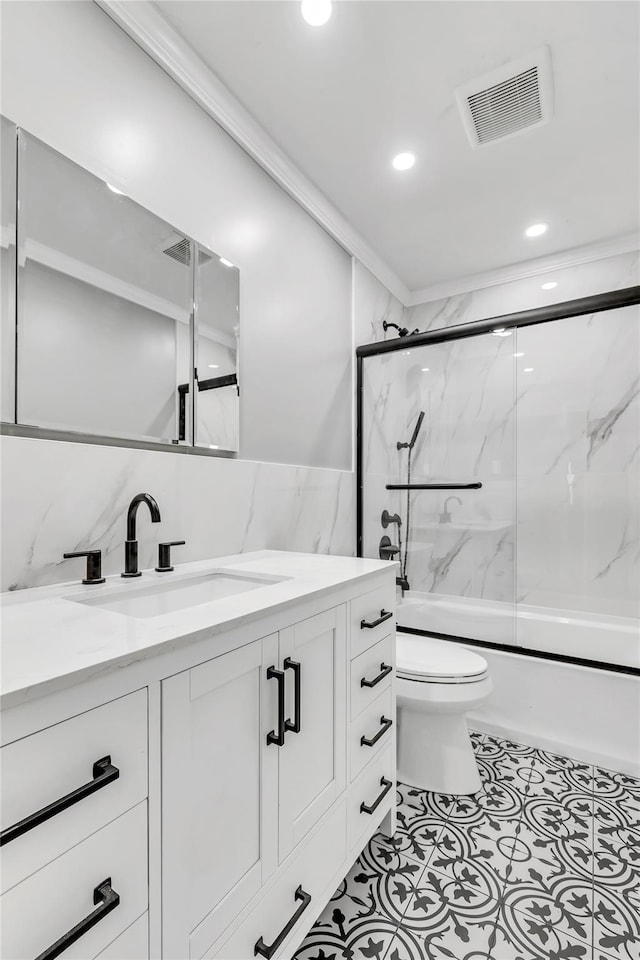 full bathroom featuring shower / bath combination with glass door, vanity, toilet, recessed lighting, and tile walls