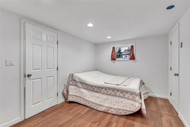 bedroom with light wood finished floors, recessed lighting, and baseboards