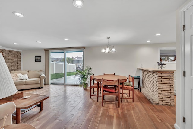 dining area featuring wood finished floors, a chandelier, and recessed lighting
