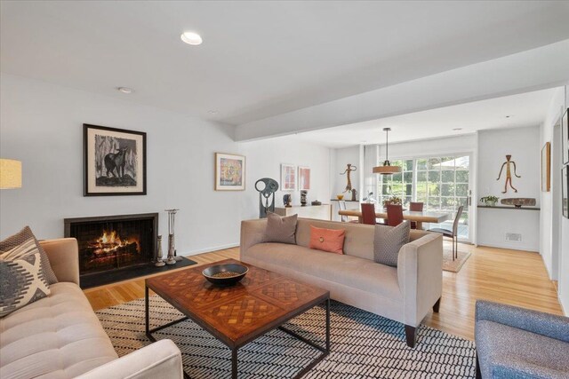 15 Scarsdale Farm Rd, Scarsdale, NY 10583 - living room featuring light wood-style floors, recessed lighting, visible vents, and a warm lit fireplace