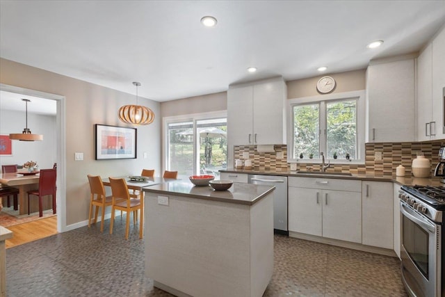 15 Scarsdale Farm Rd, Scarsdale, NY 10583 - kitchen featuring stainless steel appliances, dark countertops, backsplash, a sink, and pendant lighting