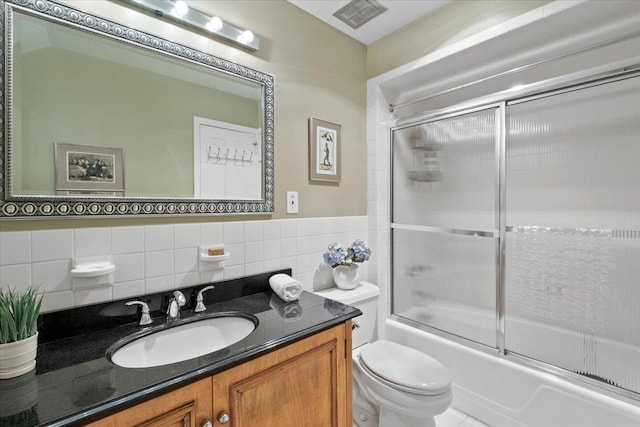15 Scarsdale Farm Rd, Scarsdale, NY 10583 - bathroom featuring tile walls, vanity, toilet, combined bath / shower with glass door, and visible vents