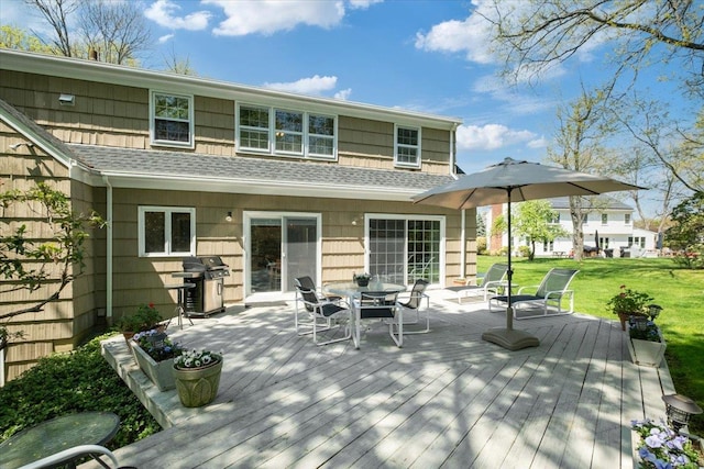 15 Scarsdale Farm Rd, Scarsdale, NY 10583 - back of property featuring a deck, outdoor dining space, a shingled roof, and a lawn