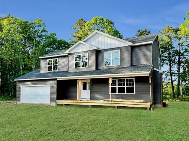 403 Moriches-Middle Island Rd, Manorville, NY 11949 - view of front of house featuring a front lawn, covered porch, and a garage