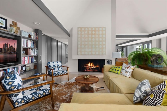 living room featuring a warm lit fireplace