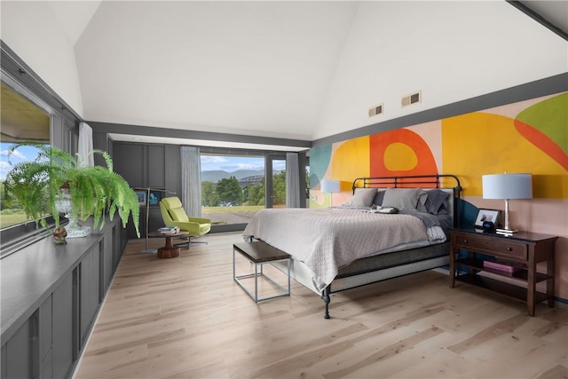 bedroom with visible vents, high vaulted ceiling, and light wood-type flooring