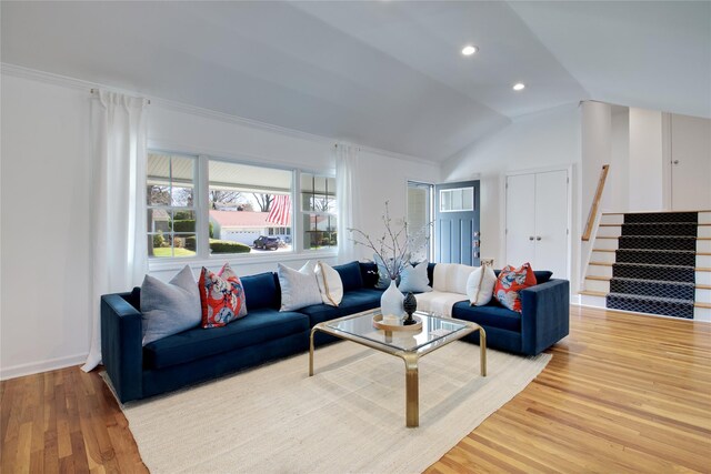 living room featuring baseboards, light wood finished floors, recessed lighting, stairs, and lofted ceiling