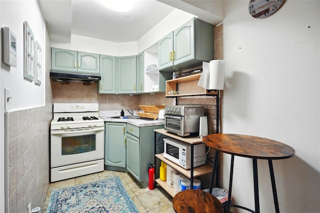132-61 41st Rd Unit 502, Flushing, NY 11355 - kitchen with white appliances, green cabinets, under cabinet range hood, light countertops, and light tile patterned flooring