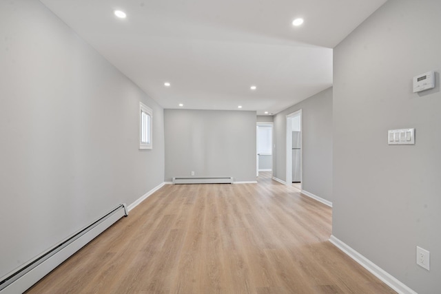 208 Newport Rd, Uniondale, NY 11553 - empty room featuring baseboard heating, a baseboard heating unit, baseboards, recessed lighting, and light wood finished floors