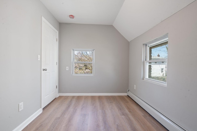 208 Newport Rd, Uniondale, NY 11553 - interior space featuring light wood-type flooring, a baseboard radiator, baseboards, and lofted ceiling