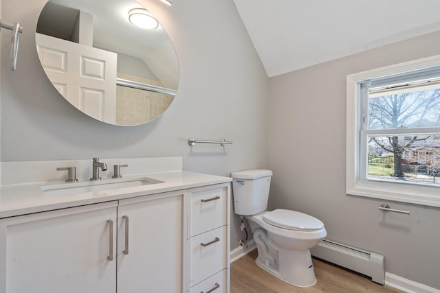 208 Newport Rd, Uniondale, NY 11553 - bathroom featuring vanity, wood finished floors, lofted ceiling, a baseboard radiator, and baseboards