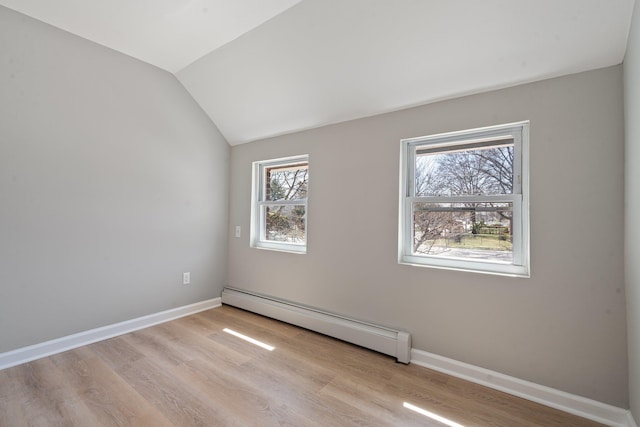 208 Newport Rd, Uniondale, NY 11553 - unfurnished room featuring a baseboard radiator, wood finished floors, baseboards, and lofted ceiling