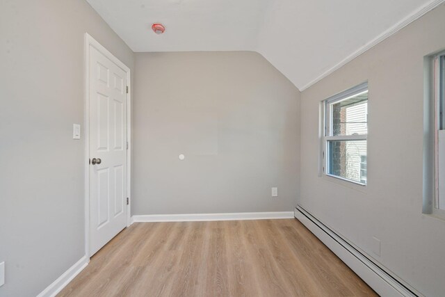 208 Newport Rd, Uniondale, NY 11553 - unfurnished room featuring light wood-type flooring, a baseboard heating unit, baseboards, and lofted ceiling