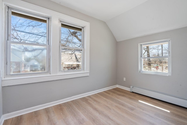 208 Newport Rd, Uniondale, NY 11553 - bonus room featuring baseboards, light wood finished floors, a baseboard heating unit, and lofted ceiling