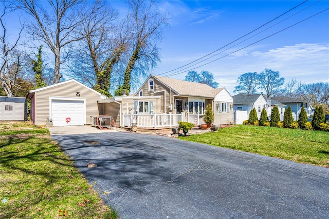 25 Snyder St, Patchogue, NY 11772 - ranch-style house with a detached garage, an outdoor structure, a front lawn, a wooden deck, and driveway