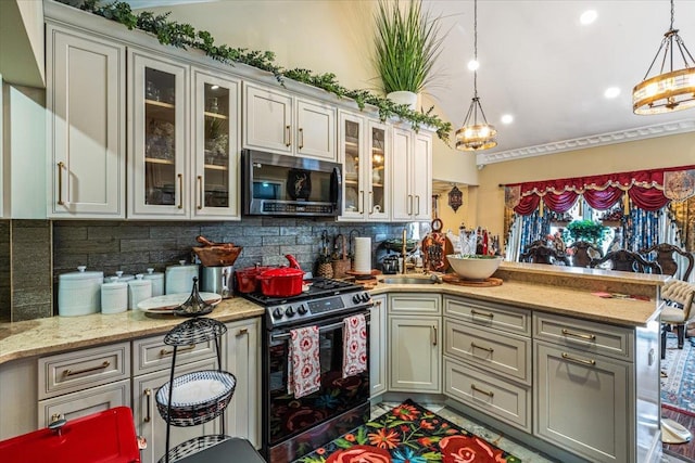25 Snyder St, Patchogue, NY 11772 - kitchen featuring a peninsula, stainless steel microwave, hanging light fixtures, gas range oven, and backsplash