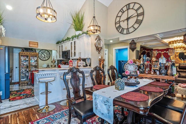 25 Snyder St, Patchogue, NY 11772 - dining space with an inviting chandelier, wood finished floors, and lofted ceiling