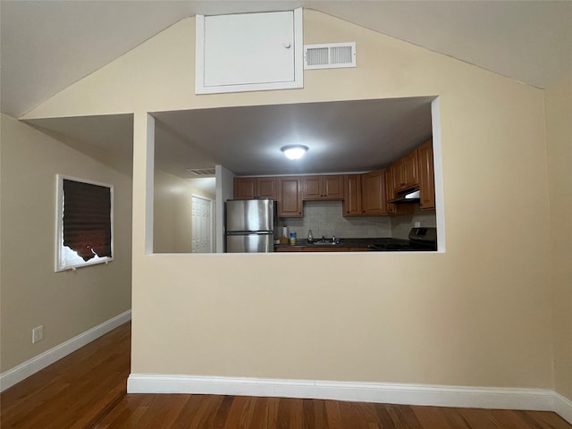 1101 Harding Park, Bronx, NY 10473 - kitchen with freestanding refrigerator, vaulted ceiling, range, under cabinet range hood, and a peninsula