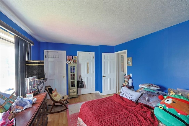 bedroom featuring a textured ceiling and wood finished floors