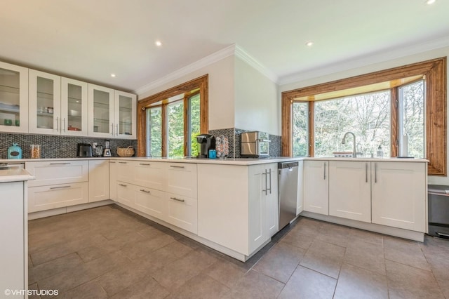 kitchen featuring stainless steel dishwasher, decorative backsplash, ornamental molding, white cabinetry, and light tile patterned floors