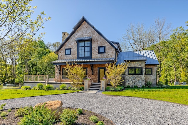 139A N Ferry Rd, Shelter Island, NY 11964 - view of front of home with a standing seam roof, covered porch, a chimney, and a front yard