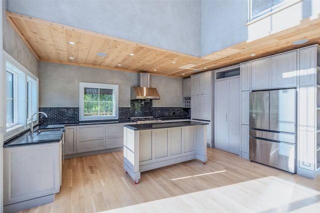 139A N Ferry Rd, Shelter Island, NY 11964 - kitchen with freestanding refrigerator, dark countertops, wood ceiling, light wood finished floors, and a sink