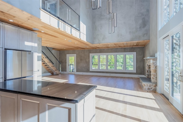 139A N Ferry Rd, Shelter Island, NY 11964 - kitchen with freestanding refrigerator, light wood-style floors, a towering ceiling, a kitchen island, and open floor plan