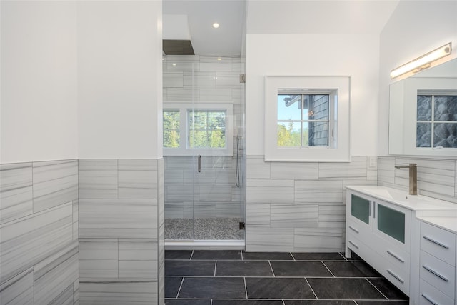 139A N Ferry Rd, Shelter Island, NY 11964 - bathroom with tile walls, tile patterned flooring, vanity, a shower stall, and wainscoting