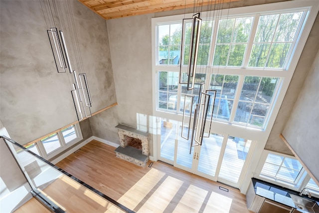 139A N Ferry Rd, Shelter Island, NY 11964 - unfurnished living room featuring wood finished floors, healthy amount of natural light, baseboards, and wood ceiling
