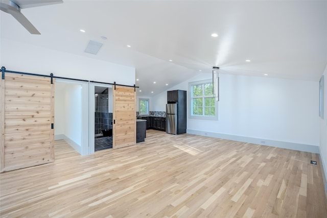 139A N Ferry Rd, Shelter Island, NY 11964 - unfurnished living room featuring a barn door, light wood finished floors, vaulted ceiling, a ceiling fan, and recessed lighting