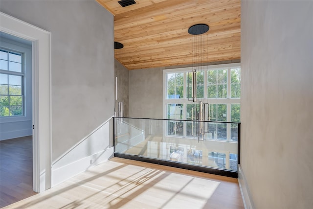 139A N Ferry Rd, Shelter Island, NY 11964 - unfurnished room featuring wooden ceiling, plenty of natural light, wood finished floors, and baseboards