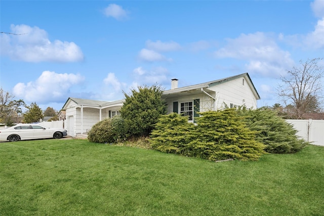 view of front of property featuring a garage, a chimney, a front yard, and fence
