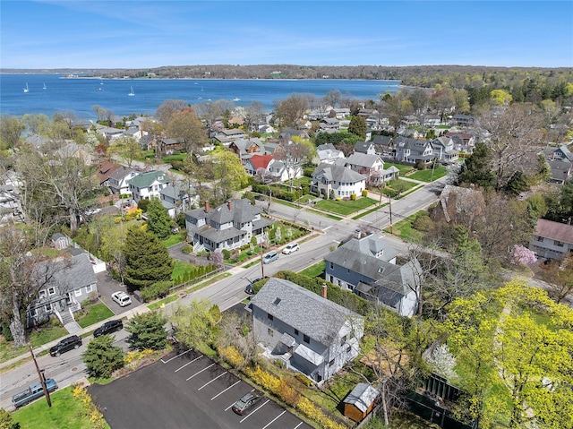 drone / aerial view featuring a residential view and a water view