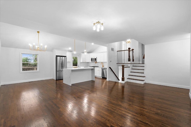 unfurnished living room with lofted ceiling, dark wood-style flooring, a notable chandelier, and baseboards
