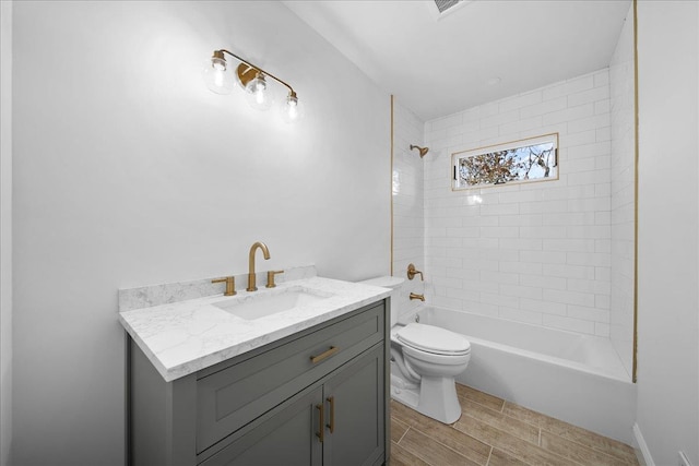 full bathroom featuring toilet, wood tiled floor, vanity, and shower / bathing tub combination