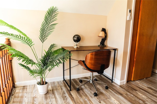 home office with wood finished floors and baseboards