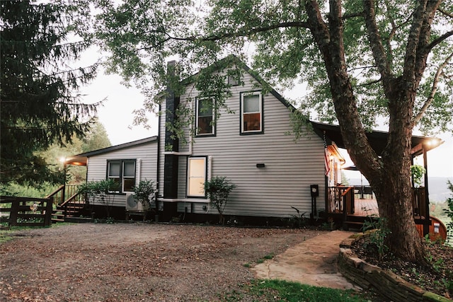 back of house with a deck