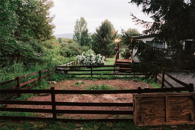 view of gate with fence and a deck