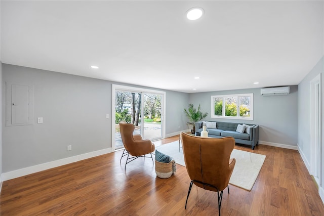 16 Huckleberry Ln, Oyster Bay, NY 11771 - living room featuring recessed lighting, a wall mounted AC, a healthy amount of sunlight, and baseboards