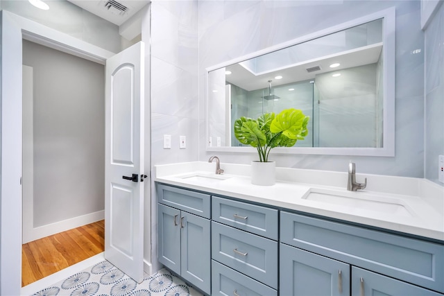 16 Huckleberry Ln, Oyster Bay, NY 11771 - bathroom featuring double vanity, a shower stall, visible vents, and a sink