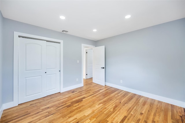 16 Huckleberry Ln, Oyster Bay, NY 11771 - unfurnished bedroom with a closet, light wood-type flooring, visible vents, and baseboards