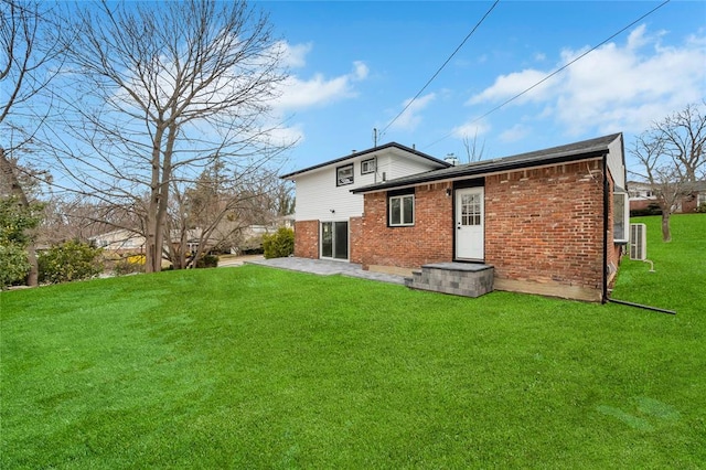 16 Huckleberry Ln, Oyster Bay, NY 11771 - back of property featuring brick siding, a patio area, and a lawn