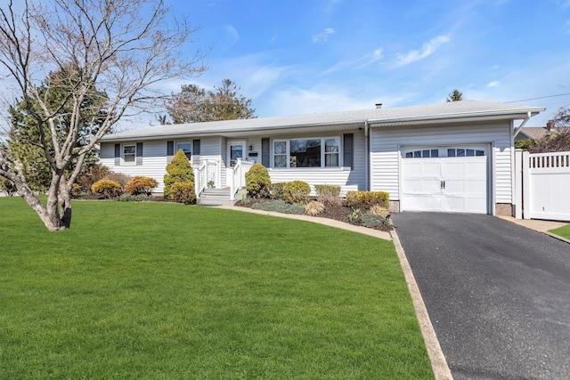 single story home with driveway, a garage, fence, and a front lawn