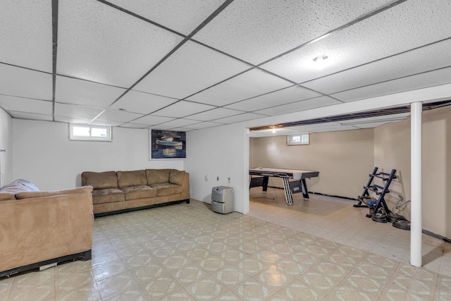 living room featuring a paneled ceiling and light floors