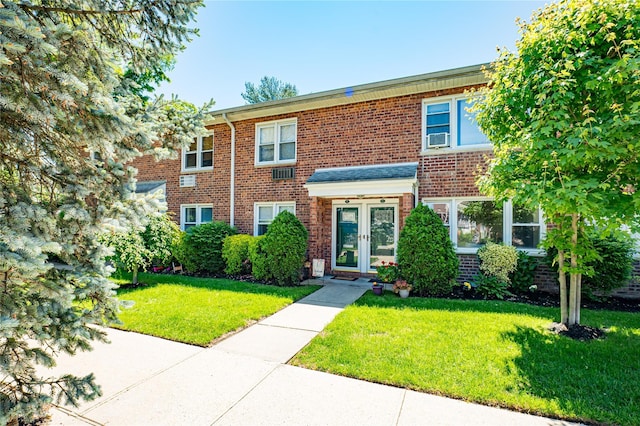 1600 Grand Ave Unit T2, Baldwin, NY 11510 - view of property featuring french doors, a front lawn, and brick siding