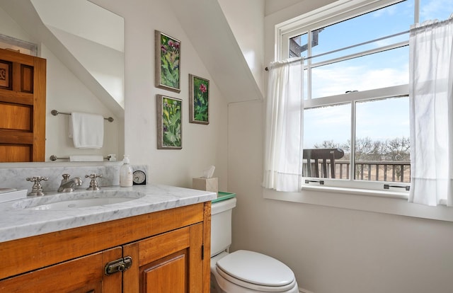 half bathroom featuring toilet and vanity
