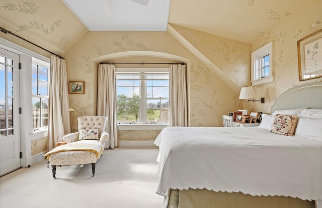 carpeted bedroom with baseboards, vaulted ceiling, wallpapered walls, and a ceiling fan