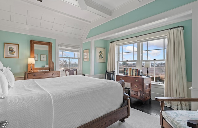 bedroom with wood finished floors and lofted ceiling with beams